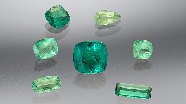 Figure 1. These seven stones (0.24–1.44 ct) ranging in color from yellowish green to bluish green were identified as the rare gem haüyne. Photo by Annie Haynes. Figure 1. These seven stones (0.24–1.44 ct) ranging in color from yellowish green to bluish green were identified as the rare gem haüyne. Photo by Annie Haynes.