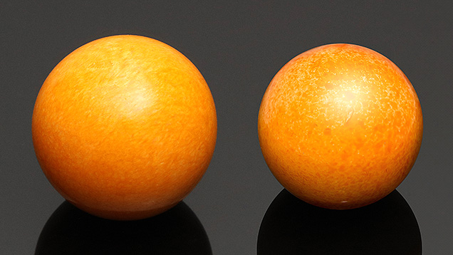 Figure 1. A 140.58 ct dyed calcite sphere (left) and an 89.81 ct round dyed and coated shell (right), both resembling Melo pearls. Photos by Johnny (Chak Wan) Leung (left) and Lhapsin Nillapat (right). Figure 1. A 140.58 ct dyed calcite sphere (left) and an 89.81 ct round dyed and coated shell (right), both resembling Melo pearls. Photos by Johnny (Chak Wan) Leung (left) and Lhapsin Nillapat (right).
