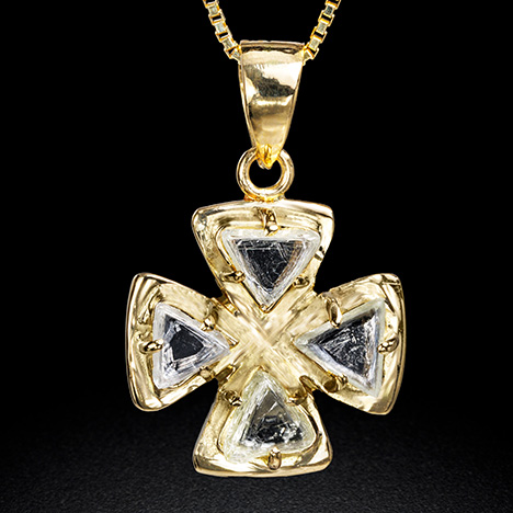 Figure 14. A gold pendant adorned with four flattened triangular macle rough diamonds with re-entrant corners belonging to morphology groups III and IV, weighing 0.945 total carats. Photo by Tetsuya Chikayama. Figure 14. A gold pendant adorned with four flattened triangular macle rough diamonds with re-entrant corners belonging to morphology groups III and IV, weighing 0.945 total carats. Photo by Tetsuya Chikayama.