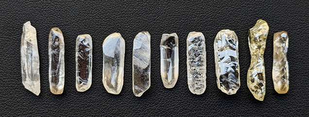 Figure 3. Elongate rough diamonds reminiscent of baguette cuts, ranging from 1.84 to 7.10 ct in weight and 16 to 24 mm in length. Photo by Evan M. Smith. Figure 3. Elongate rough diamonds reminiscent of baguette cuts, ranging from 1.84 to 7.10 ct in weight and 16 to 24 mm in length. Photo by Evan M. Smith.
