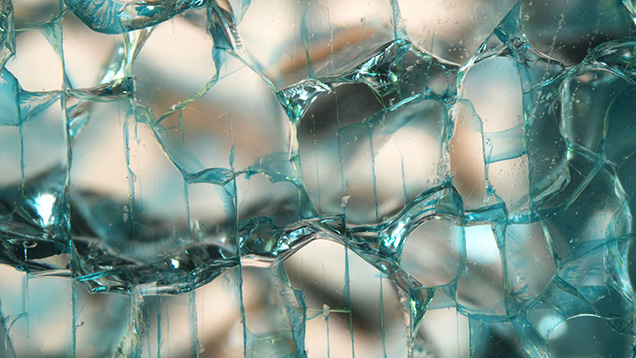 Figure 3. Dye concentrations along shallow, weblike induced fractures evenly spaced across the surface of a colorless laboratory-grown sapphire. Photomicrograph by Jamie Price; field of view 5.50 mm. Figure 3. Dye concentrations along shallow, weblike induced fractures evenly spaced across the surface of a colorless laboratory-grown sapphire. Photomicrograph by Jamie Price; field of view 5.50 mm.