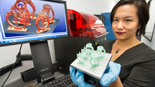 Michelle Loon, a recent graduate of GIA’s Jewelry Design Technology program, holds the build platform containing the 3-D-printed resin prototypes of her jewelry design. Photo by Kevin Schumacher Michelle Loon, a recent graduate of GIA’s Jewelry Design Technology program, holds the build platform containing the 3-D-printed resin prototypes of her jewelry design. Photo by Kevin Schumacher
