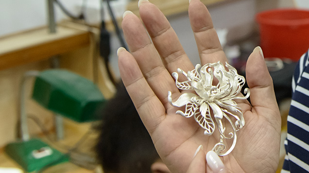 In the molding department of her jewelry manufacturing studio in Shenzhen, Shirley displays a silver mold of one of her designs. In the molding department of her jewelry manufacturing studio in Shenzhen, Shirley displays a silver mold of one of her designs.