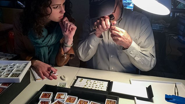 JTV staff looks at a dealer’s gemstones