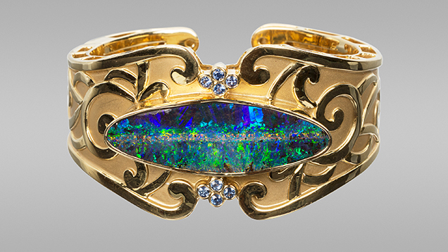 Boulder opal and sapphires in cuff bracelet. Boulder opal and sapphires in cuff bracelet.