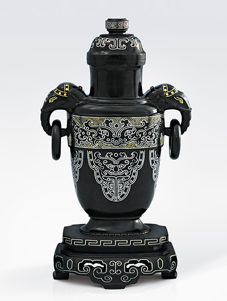 Dark gray nephrite vessel showcases elaborate gold inlay. Dark gray nephrite vessel showcases elaborate gold inlay.