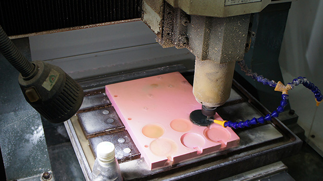 Tabular nephrite being engraved by a three-shaft CNC machine. Tabular nephrite being engraved by a three-shaft CNC machine.