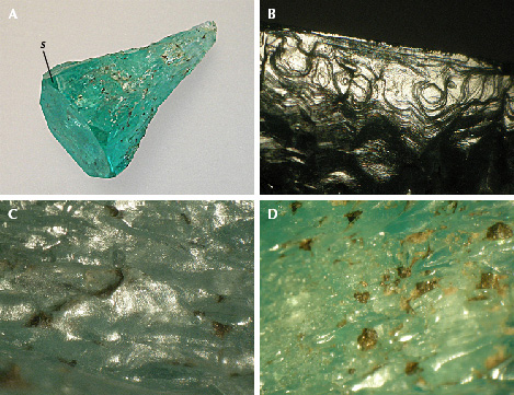 Figure 10. A: Sample 9 (20.8 mm in length), an emerald crystal with conical shape, with basal pinacoid c, small m prism faces, and hexagonal s dipyramids. B: Growth steps on the surface of one of the m prism faces, viewed almost perpendicular to the c-axis. C: Hillocks with fine micro-steps between irregularly shaped groves on the surface of the conical part. D: Residual dark gray carbonaceous material captured in indentations on the surface of the conical part. Photos by K. Schmetzer; fields of view 4.5 mm (B), 3.5 mm (C), and 7.6 mm (D). Figure 10. A: Sample 9 (20.8 mm in length), an emerald crystal with conical shape, with basal pinacoid c, small m prism faces, and hexagonal s dipyramids. B: Growth steps on the surface of one of the m prism faces, viewed almost perpendicular to the c-axis. C: Hillocks with fine micro-steps between irregularly shaped groves on the surface of the conical part. D: Residual dark gray carbonaceous material captured in indentations on the surface of the conical part. Photos by K. Schmetzer; fields of view 4.5 mm (B), 3.5 mm (C), and 7.6 mm (D).