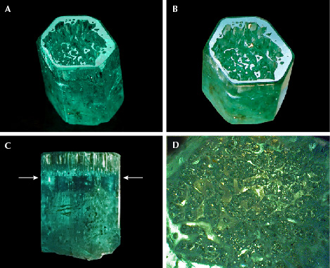 Figure 16. A: Sample 16 (10.8 mm in length), an emerald crystal developed in the form of a cup. B: The basal plane of the cup reflects together with the basal faces of small hillocks or columns in the cup. C: The bottom of the cup is located in the upper half of the crystal, as indicated by arrows. D: Framework of irregular hillocks, columns, and walls on the bottom of the cup in a view parallel to the c-axis. Photos by G. Martayan (A) and K. Schmetzer (B–D); field of view 4.6 mm (D). Figure 16. A: Sample 16 (10.8 mm in length), an emerald crystal developed in the form of a cup. B: The basal plane of the cup reflects together with the basal faces of small hillocks or columns in the cup. C: The bottom of the cup is located in the upper half of the crystal, as indicated by arrows. D: Framework of irregular hillocks, columns, and walls on the bottom of the cup in a view parallel to the c-axis. Photos by G. Martayan (A) and K. Schmetzer (B–D); field of view 4.6 mm (D).