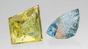 Figure 1. This 109.68 ct heliodor and 80.62 ct bicolor topaz are from the Volyn deposit in Ukraine. They are cut to leave natural etch faces on the pavilion/culet, while the crown and table are faceted. Photo by Robert Weldon; courtesy of Nomad’s.