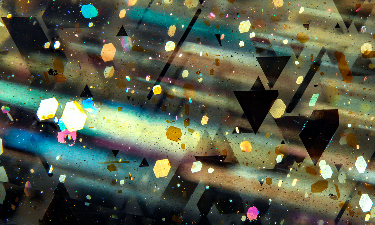 Figure 1. Parallel rays of golden, pink, and blue light were observed in this sample of rainbow lattice sunstone. Photomicrograph by Rosie Young; field of view 5.33 mm. Figure 1. Parallel rays of golden, pink, and blue light were observed in this sample of rainbow lattice sunstone. Photomicrograph by Rosie Young; field of view 5.33 mm.