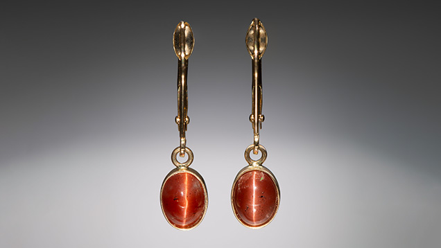Figure 1. Cat’s-eye labradorite earrings set in 14K gold. The stones measure 7 × 5 mm. Photo by Kevin Schumacher; courtesy of Ben Kho Gems. Figure 1. Cat’s-eye labradorite earrings set in 14K gold. The stones measure 7 × 5 mm. Photo by Kevin Schumacher; courtesy of Ben Kho Gems.