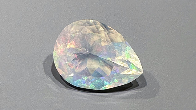 Figure 3. Highly transparent pear-shaped crystal opal from Mexico showing play-of-color. The opal measures 22.2 × 16.7 mm and weighs 17.82 ct. Photo by Jennifer Stone-Sundberg; courtesy of Columbia Gem House. Figure 3. Highly transparent pear-shaped crystal opal from Mexico showing play-of-color. The opal measures 22.2 × 16.7 mm and weighs 17.82 ct. Photo by Jennifer Stone-Sundberg; courtesy of Columbia Gem House.