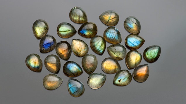 Figure 4. Colorful 8 × 10 mm teardrop labradorite cabochons. Photo by Kevin Schumacher; courtesy of Shanghai Jade Gems Factory. Figure 4. Colorful 8 × 10 mm teardrop labradorite cabochons. Photo by Kevin Schumacher; courtesy of Shanghai Jade Gems Factory.