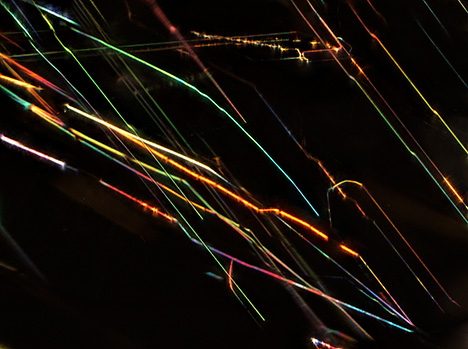 Thin-film iridescence of musgravite viewed using oblique fiber-optic illumination.