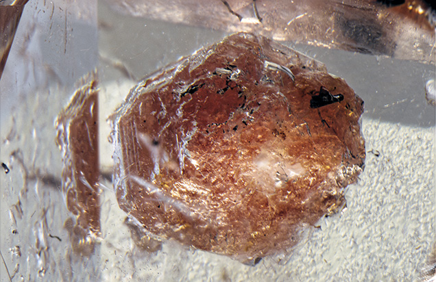 The inclusion is identified as triplite. The inclusion is identified as triplite.