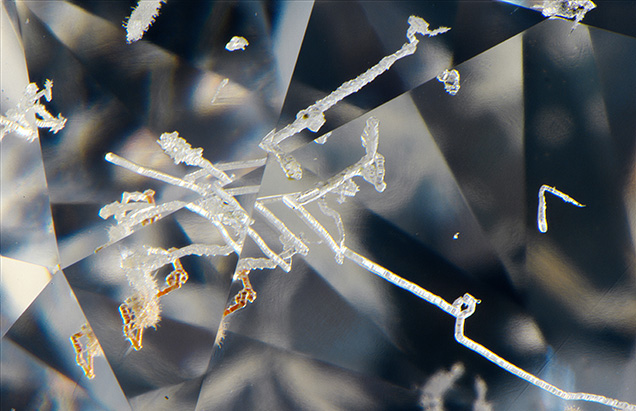 Natural etch channels and evidence of brown radiation stains in diamond.