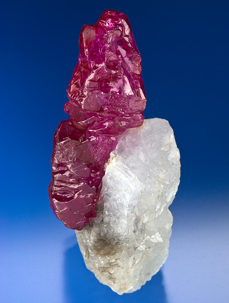 Figure 10. A 97.3 ct rough ruby crystal on calcite (marble) from Myanmar. Photo by Robert Weldon; courtesy of Pala International. Figure 10. A 97.3 ct rough ruby crystal on calcite (marble) from Myanmar. Photo by Robert Weldon; courtesy of Pala International.