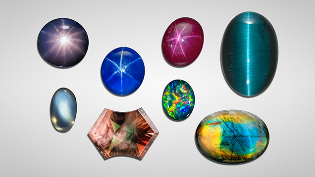 A collection of various gemstones in different shapes and colors, including blues, greens, and purples, displayed on a light background. A collection of various gemstones in different shapes and colors, including blues, greens, and purples, displayed on a light background.