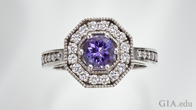 The tanzanite center stone is framed by diamonds in an octagonal frame. The tanzanite center stone is framed by diamonds in an octagonal frame.
