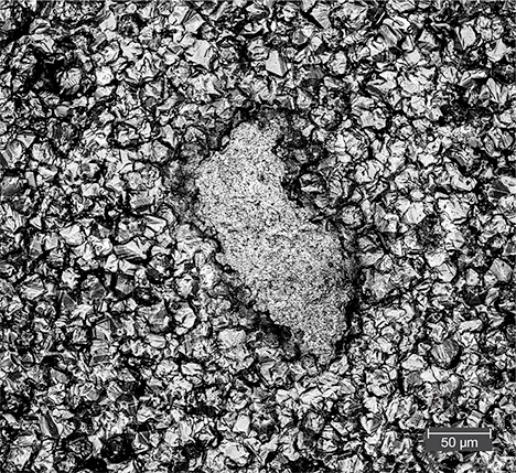 Irregularly shaped impurity center within a gold tarnish spot Irregularly shaped impurity center within a gold tarnish spot