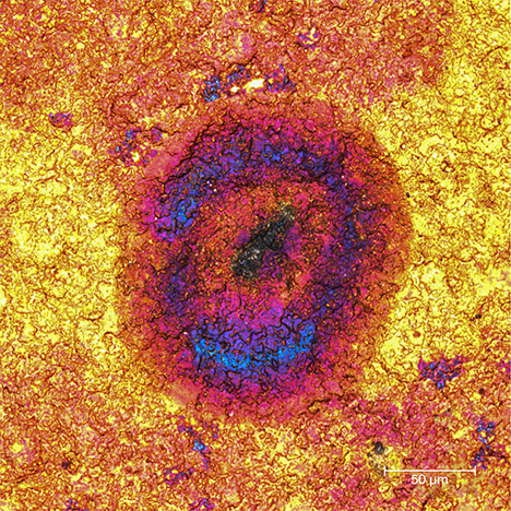 Pink and blue zones, impurity center within a gold tarnish spot Pink and blue zones, impurity center within a gold tarnish spot