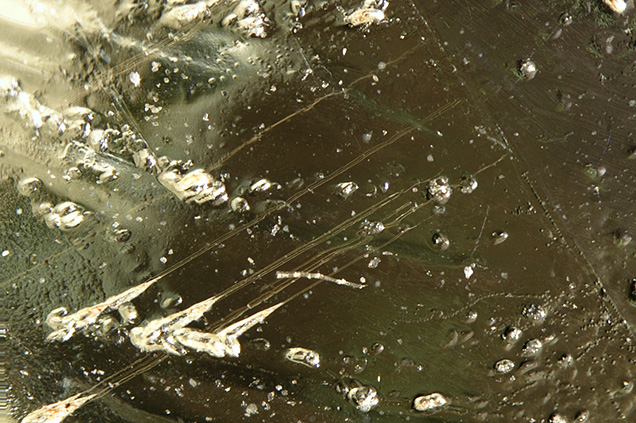 Etch tubes extended from surface etch pits and ended at the twinning plane.