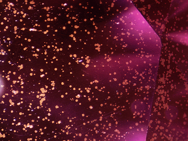 Metallic flakes on the surface of the synthetic moissanite Metallic flakes on the surface of the synthetic moissanite
