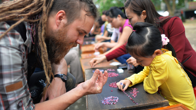 Field gemologist checks spinel at Vietnamese market