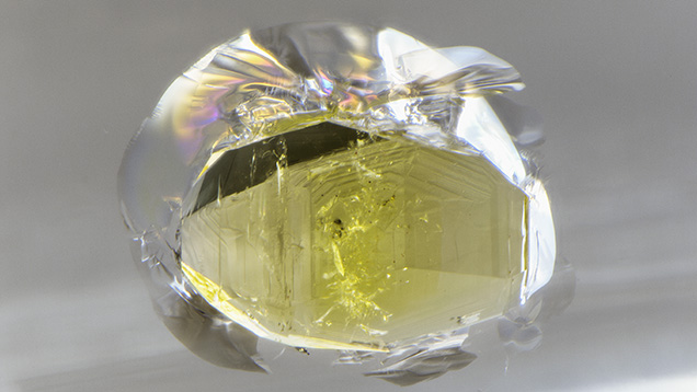 Stress cracks are clearly visible around the monzanite (?) inclusion.