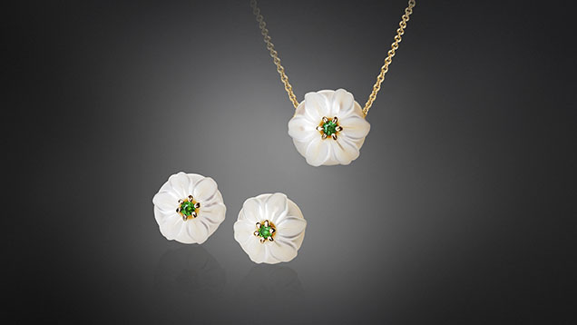 Figure 10. Carved pearls can be mounted with a variety of colored gemstones such as the “Lily” jewelry set shown here. The set is made of 11 mm hand-carved freshwater pearls and emerald mounted with 14K yellow gold. Courtesy of Chi Huynh. Figure 10. Carved pearls can be mounted with a variety of colored gemstones such as the “Lily” jewelry set shown here. The set is made of 11 mm hand-carved freshwater pearls and emerald mounted with 14K yellow gold. Courtesy of Chi Huynh.