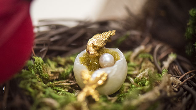 Figure 11. In this “Mother’s Love” pendant, a large pearl was carved to resemble a bird’s nest and decorated with small gemstone druzy, a round pearl, and a bird made of gold. Photo by Kevin Schumacher. Figure 11. In this “Mother’s Love” pendant, a large pearl was carved to resemble a bird’s nest and decorated with small gemstone druzy, a round pearl, and a bird made of gold. Photo by Kevin Schumacher.