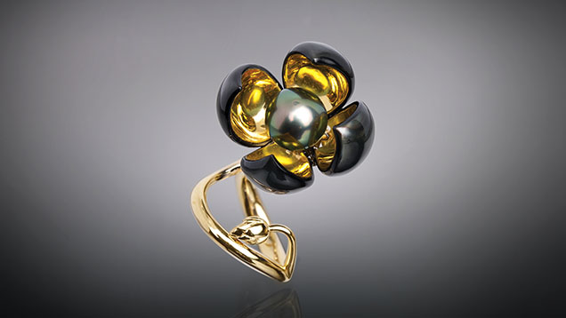 Figure 16. Shape-memory jewelry in the Blossom collection uses nitinol, a self-expanding titanium and nickel alloy that can transform in response to heat. This ring’s four flower petals are embedded with nitinol wires trained to gradually open and close based on temperature. Courtesy of Chi Huynh. Figure 16. Shape-memory jewelry in the Blossom collection uses nitinol, a self-expanding titanium and nickel alloy that can transform in response to heat. This ring’s four flower petals are embedded with nitinol wires trained to gradually open and close based on temperature. Courtesy of Chi Huynh.