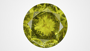 Figure 1. The face-up view of a 2.32 ct faceted pallasitic peridot, the largest extraterrestrial peridot seen at GIA to date. Photo by Diego Sanchez.