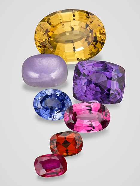 Figure 3. Alluvial gems that can more commonly be found in sediments. From left to right and top to bottom: 16.94 ct grossular, Tanzania; 9.72 ct jadeite, Myanmar; 13.52 ct spinel, Sri Lanka; 4.86 ct sapphire, Myanmar; 4.43 ct rhodolite, Tanzania; 2.53 ct rhodolite, Tanzania; and 2.21 ct ruby, Myanmar. Composite image by Robert Weldon. Figure 3. Alluvial gems that can more commonly be found in sediments. From left to right and top to bottom: 16.94 ct grossular, Tanzania; 9.72 ct jadeite, Myanmar; 13.52 ct spinel, Sri Lanka; 4.86 ct sapphire, Myanmar; 4.43 ct rhodolite, Tanzania; 2.53 ct rhodolite, Tanzania; and 2.21 ct ruby, Myanmar. Composite image by Robert Weldon.