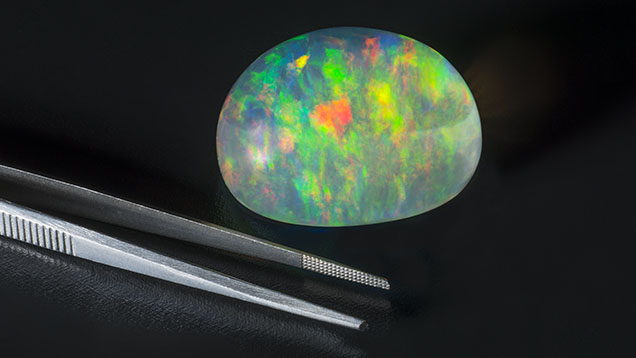Figure 13. This 264.44 ct Ethiopian opal displays a spectacular play-of-color phenomenon. Photo by Robert Weldon; courtesy of Tewodros Sintayehu, Orbit Gems, and Bill Marcue, DW Enterprises. Figure 13. This 264.44 ct Ethiopian opal displays a spectacular play-of-color phenomenon. Photo by Robert Weldon; courtesy of Tewodros Sintayehu, Orbit Gems, and Bill Marcue, DW Enterprises.