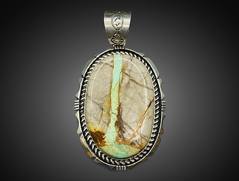 Figure 3. “Old stock” stabilized green Mona Lisa turquoise in novaculite matrix set in a silver ribbon pendant. Photo courtesy of White Horse Resale. Figure 3. “Old stock” stabilized green Mona Lisa turquoise in novaculite matrix set in a silver ribbon pendant. Photo courtesy of White Horse Resale.