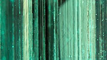 The effect of the pavilion facet edges on the dense tube inclusions in this Colombian emerald creates a scene reminiscent of a bamboo forest. Photomicrograph by Taku Okada; field of view 4.10 mm. The effect of the pavilion facet edges on the dense tube inclusions in this Colombian emerald creates a scene reminiscent of a bamboo forest. Photomicrograph by Taku Okada; field of view 4.10 mm.