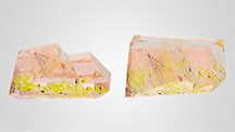 Figure 1. Two views of the 2.43 ct orangy pink morganite with bright yellow and dark brown inclusions lying in a plane. Photos by Sandie Clain, © LFG; courtesy of Gravier & Gemmes. Figure 1. Two views of the 2.43 ct orangy pink morganite with bright yellow and dark brown inclusions lying in a plane. Photos by Sandie Clain, © LFG; courtesy of Gravier & Gemmes.