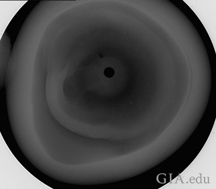 Figure 7: Microradiograph taken in the third direction (down the drill‐hole). The drill‐hole is the small black circle towards the center. Figure 7: Microradiograph taken in the third direction (down the drill‐hole). The drill‐hole is the small black circle towards the center.