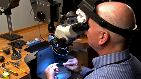 Jeweler working with various platinum tools at the bench