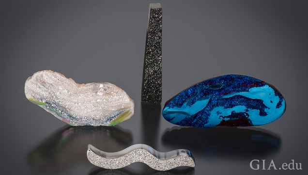 Organically shaped pieced of agate drusy with a variety of coatings. One with a silicone dioxide coating, one with a black titanium coating, one with a blue titanium coating and one with a platinum coating. Organically shaped pieced of agate drusy with a variety of coatings. One with a silicone dioxide coating, one with a black titanium coating, one with a blue titanium coating and one with a platinum coating.