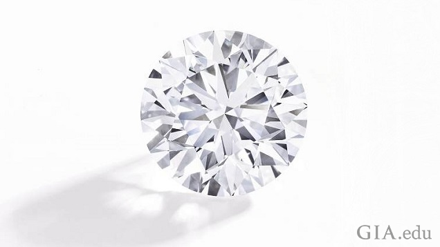 A large pear shaped diamond sits on a silver plaque with French words. A large pear shaped diamond sits on a silver plaque with French words.