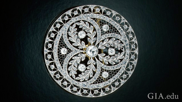 Circular pin with elaborate piercings and diamond embellishments. Circular pin with elaborate piercings and diamond embellishments.