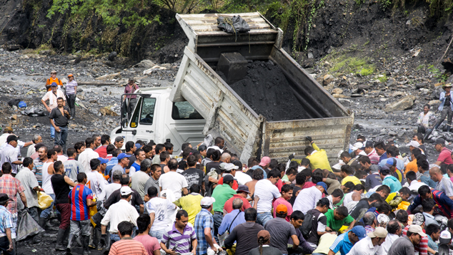 MTC trucks empty ore along the Río Itoco MTC trucks empty ore along the Río Itoco