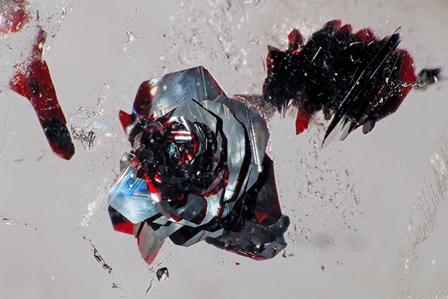 Hematite platelet in “rose” inclusion. Hematite platelet in “rose” inclusion.